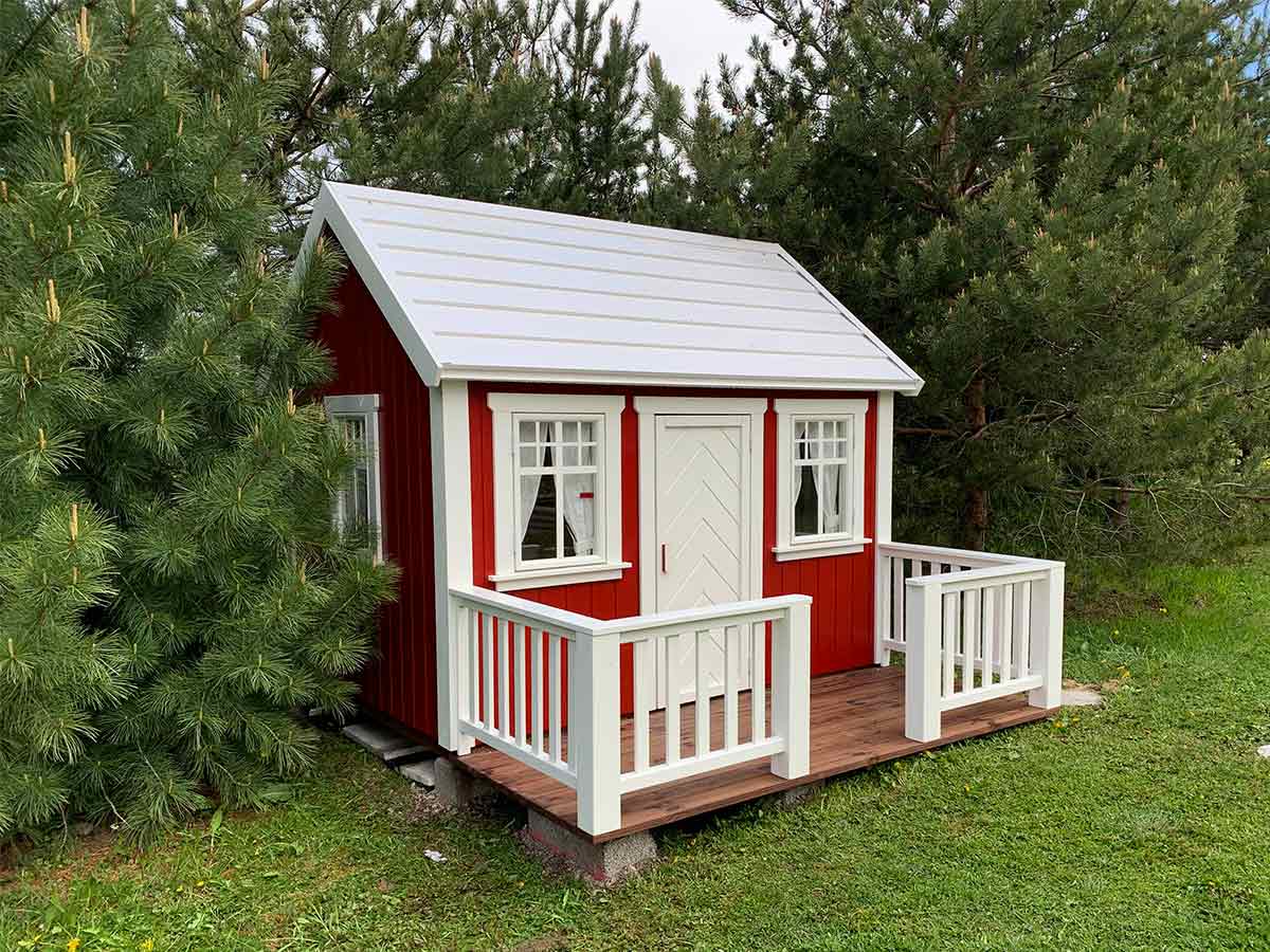 Nordic Nario playhouse with red wooden walls, white steel roof and white terrace railings left front corner view, by KidsPlayHouses_EU