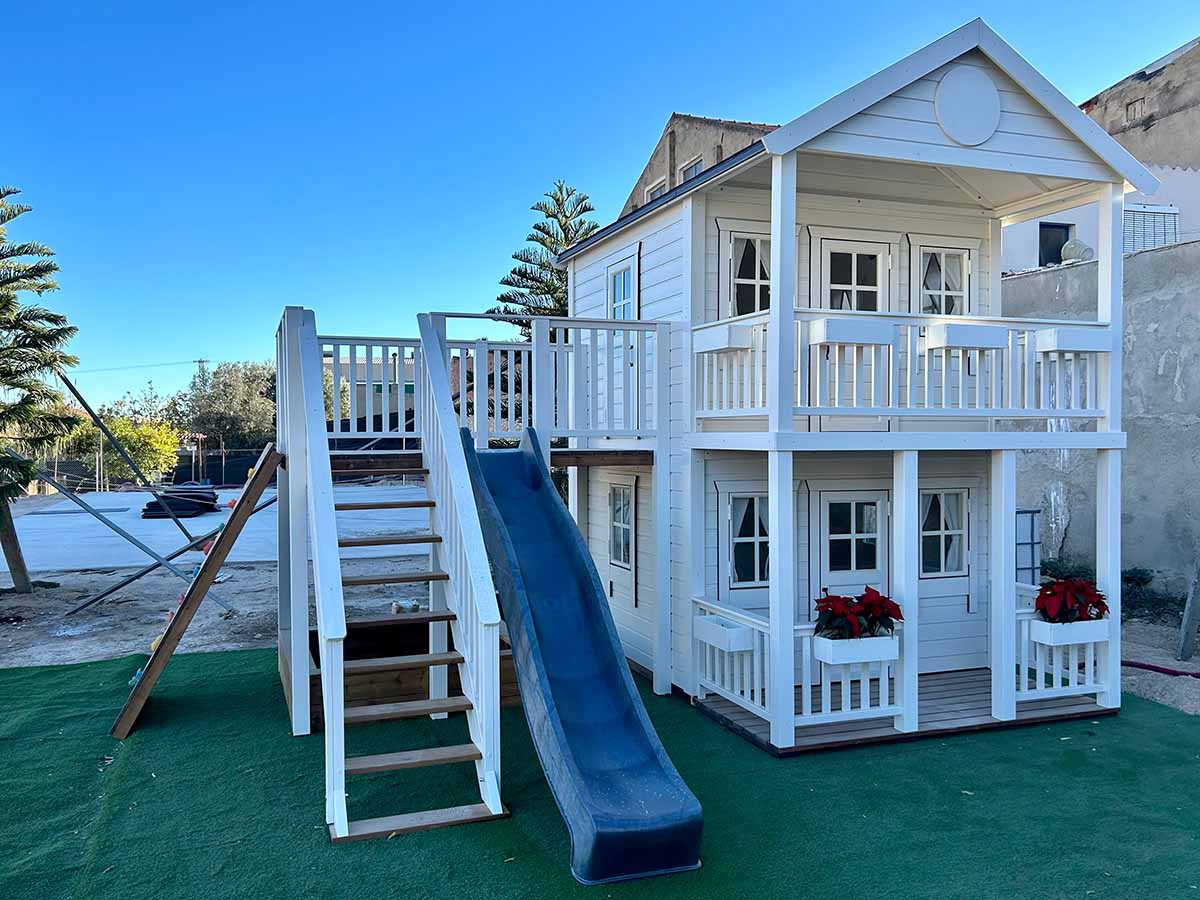 Wooden Playhouse Fairy Tale Haven front left view, slide, sandbox and climbing wall.