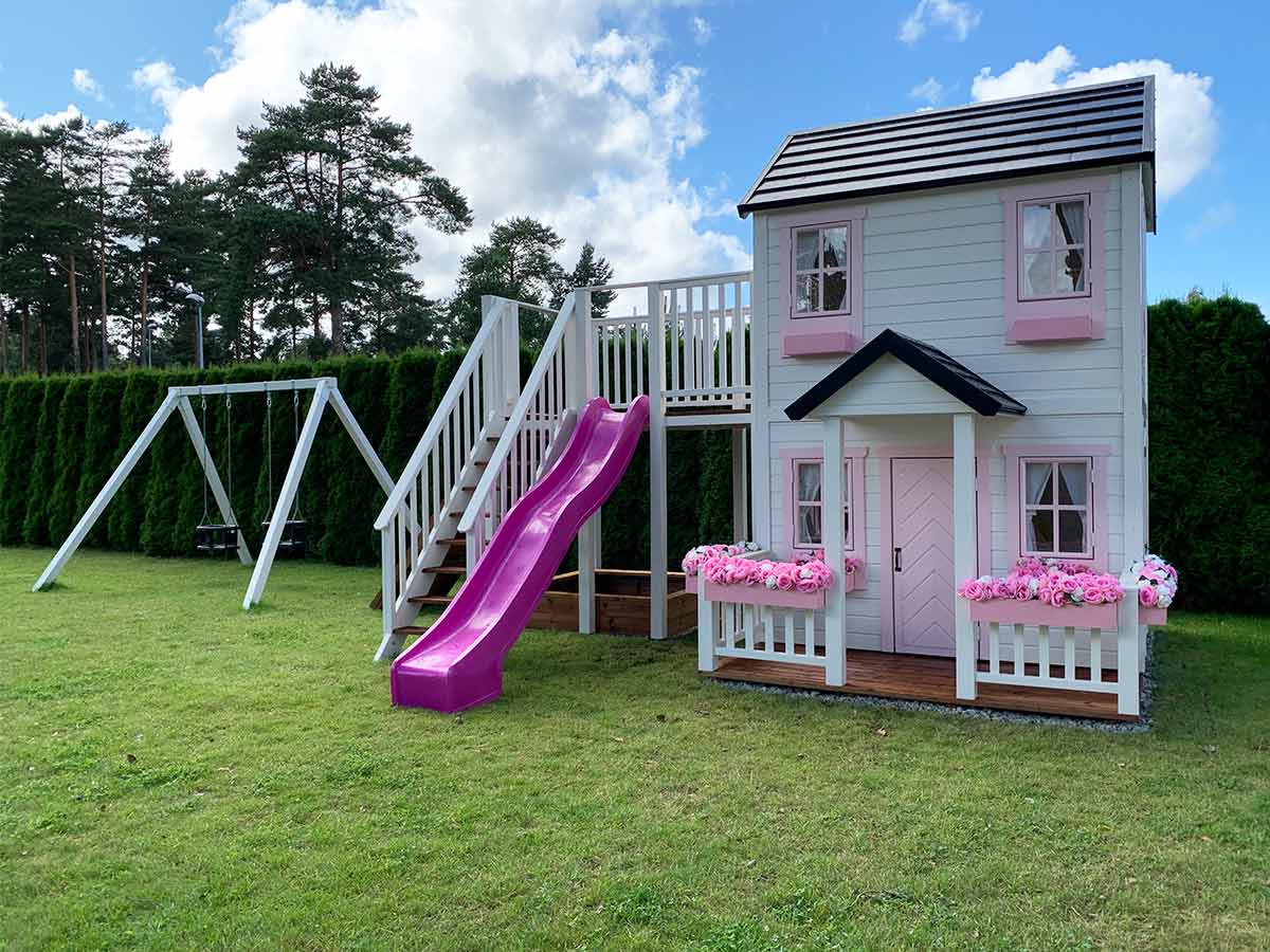 KidsPlayHouses_EU double all-wood kids playhouse Princess with slide, climbing wall and balcony and sandpit, double swing in the background.
