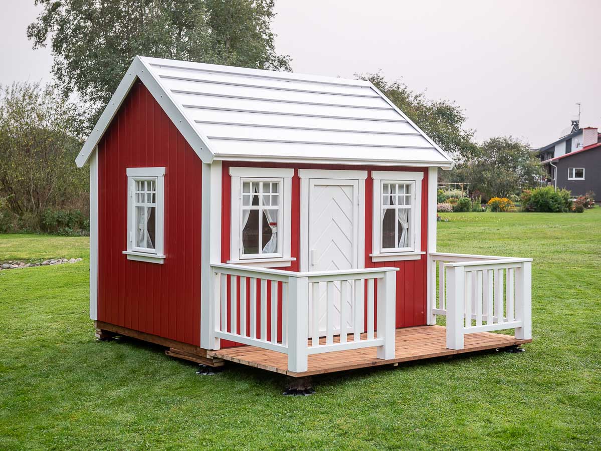 Nordic Nario Kids Playhouse with Red Walls, White Window Frames, White Metal Roof and Brown Wooden Decking and White Railings, by KidsPlayHouses_EU
