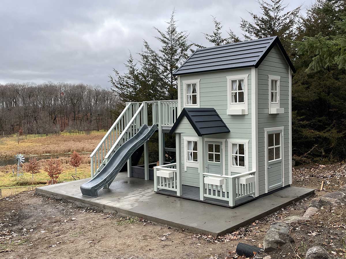 Light Gray children's playhouse Prince with a slide in a natural setting