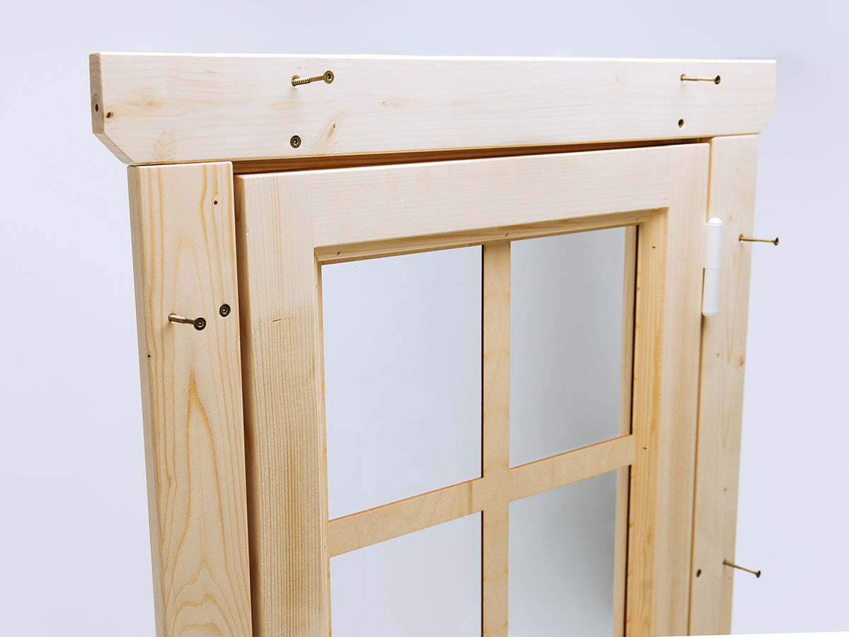 Wooden door frame with glass panes on a light blue background