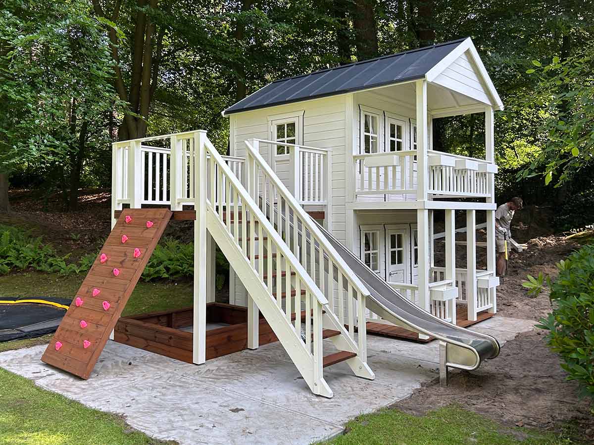 Playhouse Fairy Tale Haven with Stainless Steel Slide, Climbing Wall, Sandbox on the view from Front-Right by KidsPlayHousesEU