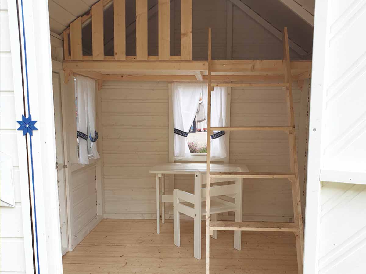 Cornflower playhouse interior view, white walls, loft, safety railing and ladder to loft, under loft kids play area, floor and chair. By KidsPlayHouses_EU