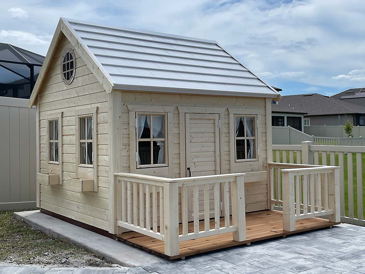 Wooden outdoor playhouse with a white steel roof, terrace and railings in the backyard
