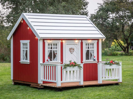 Solid wood red kids playhouse Nordic Nario decorated for Christmas, by KidsPlayHouses_EU