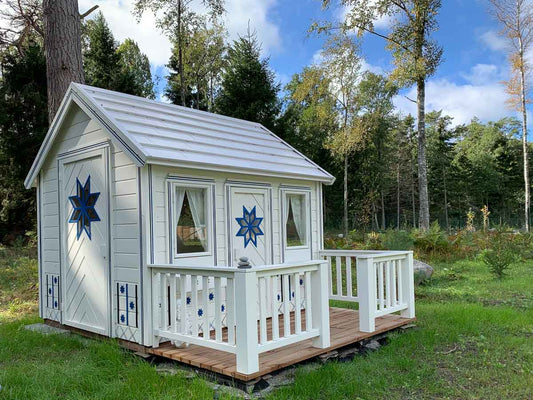KidsPlayHouses_EU a2 design solid wood quick assembly kids playhouse Cornflower, white decorated walls, terrace with railing, kids and adult door, white steel roof.